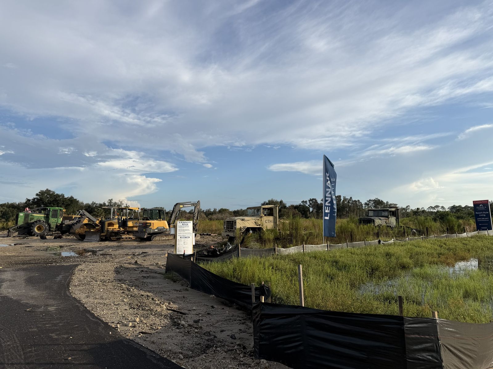 Equipment, the job-site sign and the "Coming Soon" Daniels Creek sign. Photo: Fernando Daza, October 11, 2026.