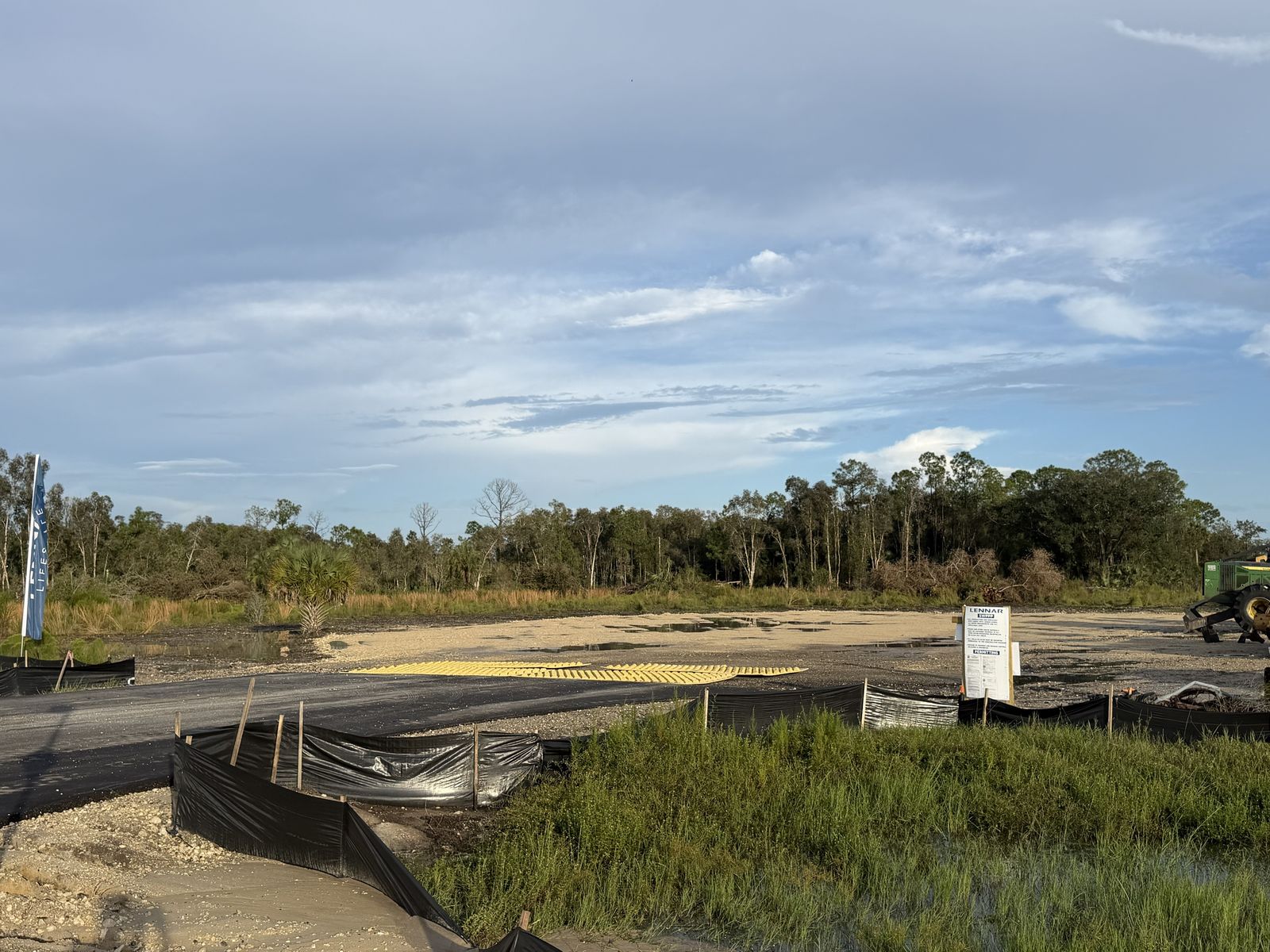 Wide view of the cleared pad, with trees beyond. Photo: Fernando Daza, October 11, 2026.
